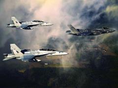 A U.S. Marine Corps F-35 aircraft is escorted by two Marine F/A-18 Hornets as it flies toward Eglin Air Force Base, Florida. Later this year, the Defense Department will establish a program of record to ensure communications between different generations of fighter aircraft, and that program will feed into the Joint Aerial Layer Network vision.