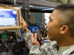 A 25th Infantry Division specialist conducts data and chat communications using a Mobile User Objective System (MUOS). The division’s top signal officer says he wants to get his hands on a new industry-developed cross-banding solution that will improve interoperability between U.S. forces and Pacific Rim partners.
