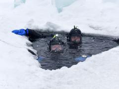 Navy divers participate in under-ice training at Camp Ripley, Minnesota, on February 8. A variety of factors, including melting Arctic ice caps, could require a greater focus on maritime operations. Photo by Navy Staff Sgt. Anthony Housey
