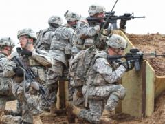 Soldiers from the 101st Airborne Division use Rifleman Radios and other tactical network technologies during a training exercise. In the future, Army officials intend to provide soldiers with a radio capable of using both the Soldier Radio Waveform, which the Rifleman Radio relies on, and the Single Channel Ground and Airborne Radio System waveform.