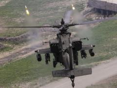 A U.S. Army AH-64 Apache fires point detonation rounds during a training exercise in South Korea. The Army intends to equip its helicopter fleet with the Small Airborne Networking Radio.