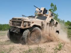 AM General's Joint Light Tactical Vehicle prototype negotiates the off-road demonstration course at the Transportation Demonstration Support Area in Quantico, Va. The yet-to-be-chosen platform is destined to carry the common VICTORY architecture for C4ISR and EW systems.