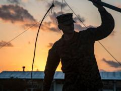Cpl. Jacob Worshan, USMC, holds an antenna during a long distance, high frequency communications training event held on Camp Schwab, Okinawa, Japan. This training between 1st and 3rd Marine Division helps the units maintain a low electromagnetic signature that is virtually impervious to jamming and interference, which allows for distributed operations without detection in the operating environment. Photo by Lance Cpl. Christian Ayers, USMC