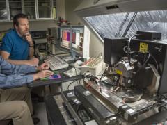 Sandia National Laboratories researchers Jon Ihlefeld (l) and David Scrymgeour use an atomic-force microscope to examine changes in a material’s phonon-scattering internal walls, before and after applying a voltage.