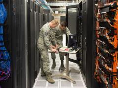 Tech. Sgt. David Mooers (l) and Senior Airman Mario Lunato, 2nd System Operations Squadron system administrators, access one of the core servers in the 557th Weather Wing enterprise at Offutt Air Force Base, Nebraska. The wing is employing specialized cybersecurity crews on top of other cyber defenses to protect weather intelligence. U.S. Air Force photo by Paul Shirk