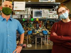 Matt Eichenfield (l) and Lisa Hackett, scientists at Sandia National Labs, recently created a groundbreaking acoustic circulator, a key radio component that separates transmitted and received signals, and is much smaller in size. Credit: Sandia National Labs/Bret Latter