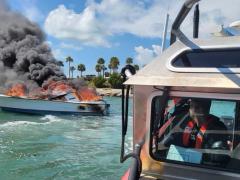 Responding to a vessel fire in the Whale Harbor Channel, near Islamorada in the Florida Keys on October 13, 2021, U.S. Coast Guard Petty Officer 3rd Class Logan Sayre manuevers with Petty Officer 3rd Class Broderick Jones (not pictured) to extinguish the flames after a Good Samaritan rescued the two passengers on board. To support its complex missions of sea rescue, homeland security and military-related operations, the service is expanding and modernizing its communications network. U.S. Coast Guard photo