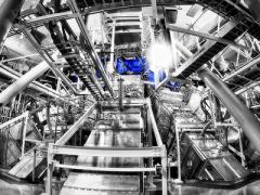 Beamlines entering the lower hemisphere of the National Ignition Facility’s target chamber. Lawrence Livermore researchers have successfully combined nine of the facility’s 192 laser beamlines into one directed pulse of light. (Photo: Damien Jemison/LLNL)