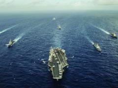The aircraft carrier USS George Washington and ships from the U.S. Navy, the Indian navy and the Japan Maritime Self-Defense Force participate in trilateral naval field training. Carrier strike groups may be increasingly vulnerable to antiship missile systems and could be better protected with the use of an integrated electronic warfare capability.