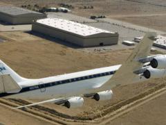 NASA's DC-8 airborne science laboratory flies over the Dryden Aircraft Operations Facility, Palmdale, California. The DC-8 is participating in ACCESS flights measuring the emissions and performance of biofuels in jet engines. (NASA Photo)