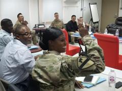 Maj. Nadine Quashie, USA, prepares to ask a question during a breakout session at a contracting symposium the 408th Contracting Support Brigade hosted at Camp Arifjan, Kuwait. Credit: U.S. Army photo by Staff Sgt. Robert Waters, USA