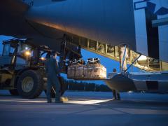 Airmen from the 37th Airlift Squadron and 86th Logistics Readiness Squadron load a low-cost low-altitude drop into a C-130J Super Hercules aircraft as the flight crew prepares for a night-time training mission during 2021 Aviation Detachment Rotation at 33rd Air Base near Powidz, Poland. The LCLA drop contents would consist of supplies or equipment for a small subset of units. Credit: U.S. Air Force photo by Senior Airman Kristof J. Rixmann