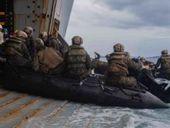 Marines and sailors aboard the amphibious assault ship USS New Orleans execute small boat drills in the Philippine Sea. Greater integration between the Navy and Marine Corps is leading to more joint operations in support of maritime security. Credit: Lance Cpl. Grace Gerlach, USMC