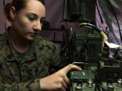 Sgt. April Vance, USMC, a field radio operator with Headquarters Regiment, 1st Marine Logistics Group, adjusts the communications network during a field training exercise at Camp Pendleton, California. Field radio operators employ a range of frequencies to establish communications, including ultrahigh frequencies, upper-very-high frequencies and high frequencies. U.S. Marine Corps Photo by Staff Sgt. Rubin J. Tan, USMC