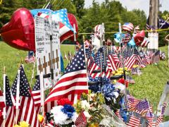 Chattanooga residents create makeshift memorials to honor and remember the victims killed by a gunman. The event raises questions about the public's view on intelligence services.