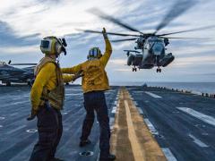 Sailors assist with the landing of a Marine Corps CH-53E Super Stallion helicopter on the deck of the U.S. Navy’s USS Wasp assault ship as part of an April certification exercise in the Philippine Sea. In its role of steering the Navy toward the best information technology for the 21st century, the Space and Naval Warfare Systems Center (SSC) Atlantic is looking at cloud computing systems to support the warfighter. Credit: Petty Officer 3rd Class Levingston Lewis, USN