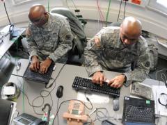 U.S. soldiers work on a Mission Event Synchronization List in the Joint Cyber Control Center during Operation Deuce Lightning in 2011.