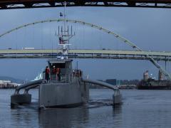 DARPA's Anti-Submarine Warfare (ASW) Continuous Trail Unmanned Vessel (ACTUV) prototype makes a dry run in Portland, Oregon. Officials christened Sea Hunter on Thursday.