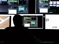 Members of the Air Force Research lab work on a new enhanced reporting, narrative event streaming tool built in cooperation with business and academia. The tool is aimed at streamlining tasks performed by intelligence analysts, which will be essential for future intelligence processes. Photo by Wesley Farnsworth