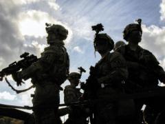 U.S. soldiers prepare for a convoy to a tactical operation center during a multinational exercise. Such exercises help the Army improve interoperability and other technology-related issues.  Spc. Randy Wren, USA