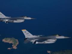 A pair of F-16 Fighting Falcons from the 80th Fighter Squadron, Kunsan Air Base, Korea fly to the range to practice procedures before an AIM-9 missile live fire exercise.