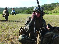 A radio operator for Combat Logistics Battalion-31, 31st Expeditionary Unit (MEU) communicates with the command element during a mass casualty evacuation exercise in Japan.