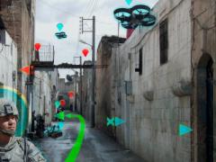 A U.S. Army soldier patrols an urban area in this artist’s concept showing aerial and ground unmanned vehicles supporting his mission as a team. The Army Research Laboratory has established a real-world testbed at Graces Quarters, Maryland, in which autonomous vehicles can be put through their paces in woods, fields, marshes and urban areas to explore similar scenarios. ARL image