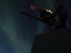 An aurora borealis appears in the night sky over the USS Thomas Hudner during an exercise in the Arctic. U.S. and allied forces are paying greater attention to operations in the Arctic and the North Atlantic in the face of an increased Russian threat. Credit: U.S. Navy photo