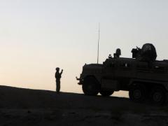 U.S. Marines conduct operations in Afghanistan as part of the International Security Assistance Force. The NATO Secret-level network in Afghanistan, outsourced to private industry, serves as an example of how future NATO information technology might be acquired through outsourcing.