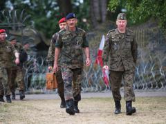 Maj. Gen. Thomas Franz, GEAF, former commander of the NATO Communications and Information Systems Group (NCISG) (c), walks with other participants during Steadfast Cobalt 15. About 39 organizations from 25 nations contributed to the exercise.