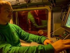 An aviation electronics technician first class performs maintenance on a mission computer aboard an MH-60R Seahawk helicopter on an aircraft carrier. The U.S. Navy seeks better computer and information systems for faster upgrades and less vulnerability to cybermarauders.