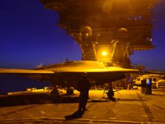 An X-47B unmanned aircraft undergoes nighttime testing aboard the USS Theodore Roosevelt. Better integration of platforms and sensors is one goal of the U.S. Navy’s Program Executive Office (PEO) for Unmanned Aviation and Strike Weapons.