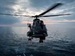 A Romanian navy helicopter prepares to land on the deck of a frigate during maneuvers by Standing NATO Maritime Group 2 in the Black Sea. The NATO Communications and Information (NCI) Agency is looking toward industry to equip its military and organizational forces with proven technologies that enhance mobile links.