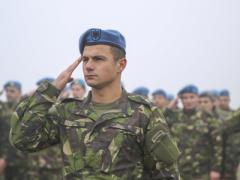 Romanian soldiers at a Romanian air base render honors with U.S. forces commemorating the 74th anniversary of the 1941 attack on Pearl Harbor. Romania’s growing activities with fellow NATO members include greater information sharing on cyberspace.