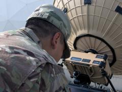 Sgt. Kevin Nguyen, USA, a team leader in the 50th Expeditionary Signal Battalion, tests the connection of a Tampa Microwave satellite dish in Camp Arifjan, Kuwait. A team of soldiers from the 50th ESB is testing the mobility and capabilities of their new equipment in locations all over the world. U.S. Army photo by Sgt. Adam Parent, USA
