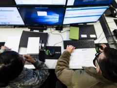 Senior Airman Rose Li, USAF (l), and Airman 1st Class Eric Gardella, USAF, 86th Communications Squadron wing cyber readiness technicians, monitor malicious network activity during exercise Tacet Venari at Ramstein Air Base, Germany, in 2020 to prepare local cyber defenders in safeguarding critical technological infrastructures. U.S. Air Force photo by Staff Sgt. Devin Boyer
