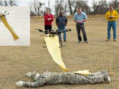 Scientists from the U.S. Army Research Laboratory test an unmanned system to deliver a blanket to a wounded soldier, part of a developing concept to use unmanned assets as protective platforms.
