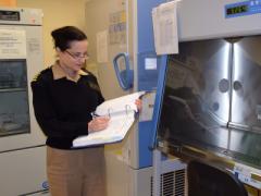 Capt. Judith Epstein, USN, clinical director of the Naval Medical Research Center’s (NMRC’s) Malaria Research Department, fills out a record book about malaria vaccine research in the clinical trials center. U.S. Navy photo by Katie Berland