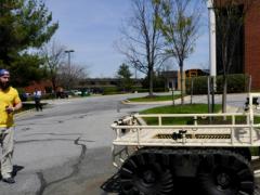 Roboteam’s Zachary Lucas maneuvers the PROBOT Military Robot, a lightweight, all-terrain carrier and reconnaissance robot that hauls three times its own weight and allows hands-free operation. The adaptable plug-and-play platform can conform to troops’ missions to carry explosives, equipment, weapons and even troops themselves.