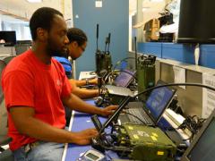Product Manager Handheld, Manpack and Small-Form Fit engineers perform tests on the manpack radio in the Unified Lab for Tactical Radios–Army (ULTR-A) facility in Maryland. The ULTR-A lab is used for radio and waveform testing and integration.