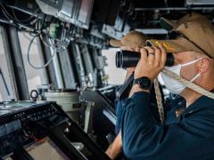 A sailor keeps watch aboard the USS John S. McCain as the guided missile destroyer asserts navigational rights and freedoms under international law in the South China Sea near the Spratly Islands. The U.S. Indo-Pacific Command (INDOPACOM) routinely conducts freedom of navigation operations as part of its mission to ensure free and secure passage in the vast region.  7th Fleet