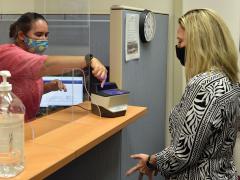 Leslie Bryant, civilian personnel office staffing chief, demonstrates how to give fingerprints to Jayme Alexander, Airmen and Family Readiness Center casualty assistance representative selectee. Although requiring fingerprints to access information is better than single-factor identification verification, it should be part of a multifactor authentication approach. Credit: 2nd Lt. Benjamin Aronson, USAF