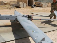 U.S. Army soldiers with Company D, 52nd Brigade Engineer Battalion, 2nd Infantry Brigade Combat Team, 4th Infantry Division, conduct a preflight inspection of an RQ-7B Shadow unmanned aerial system at a base in Iraq.