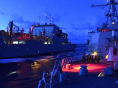 A U.S. Arleigh Burke-class guided missile destroyer refuels and resupplies in the South China Sea. The U.S. Pacific Command (PACOM) is expanding its roles and relationships in the Asia-Pacific region amid new and growing threats.