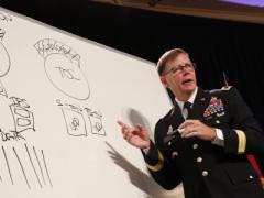 Maj. Gen. Stephen Fogarty, USA, commanding general of U.S. Army Cyber Center of Excellence at Fort Gordon, Georgia, takes to the white board to illustrate dysfunctional stovepipes that keep military disciplines from sharing information and missions. Photo by Mike Carpenter
