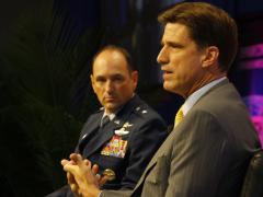Dana Deasy, the new DOD CIO (r), chats with Brig. Gen. Kevin B. Kennedy, USA, during the Defensive Cyber Operations Symposium.