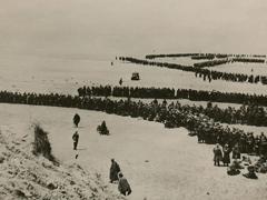Thousands of British and French troops wait on the dunes of Dunkirk Beach, France, for transport to England during World War II, between May 26 and June 4, 1940. The Central Intelligence Agency cites the military evacuation of Dunkirk as the time its predecessor agency started depending on the private sector for key strategic intelligence. Credit: Shutterstock/Everett Historical
