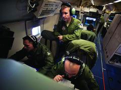 U.S. Air Force officers monitor moving target indicators during a training exercise for the Joint Surveillance and Target Attack Radar System (JSTARS).