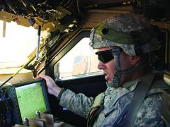 A U.S. Army soldier communicates inside his vehicle during the Army's Network Integration Evaluation (NIE) 12.2 in spring 2012.