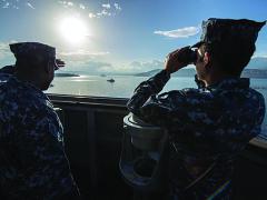 U.S. sailors on the bridge of the USS Ramage monitor a Spanish frigate as it departs Souda Bay during their scheduled deployment supporting maritime security operations and theater security cooperation efforts in the U.S. 6th Fleet area of responsibility.